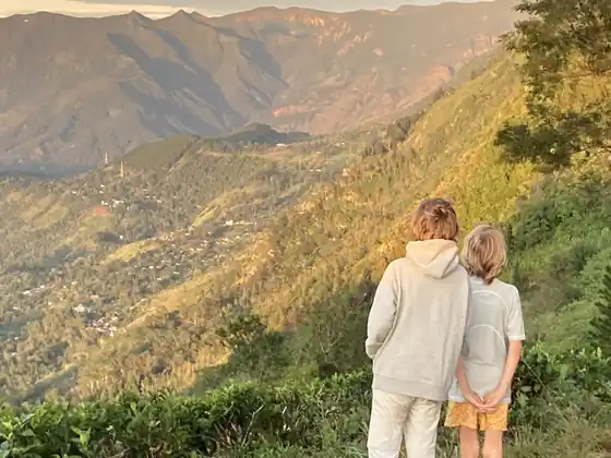 Two children looking out over the valley from the tea slopes