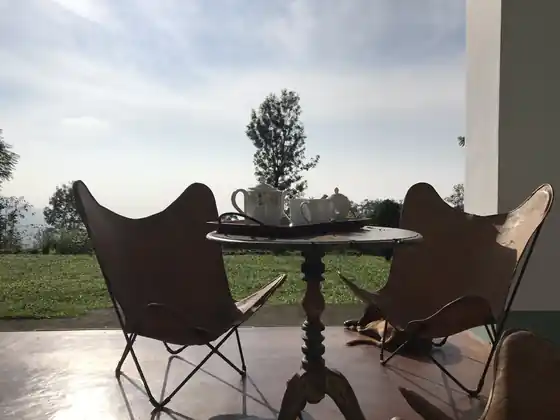 Two leather butterfly chairs and a pot of tea on the veranda overlooking the garden